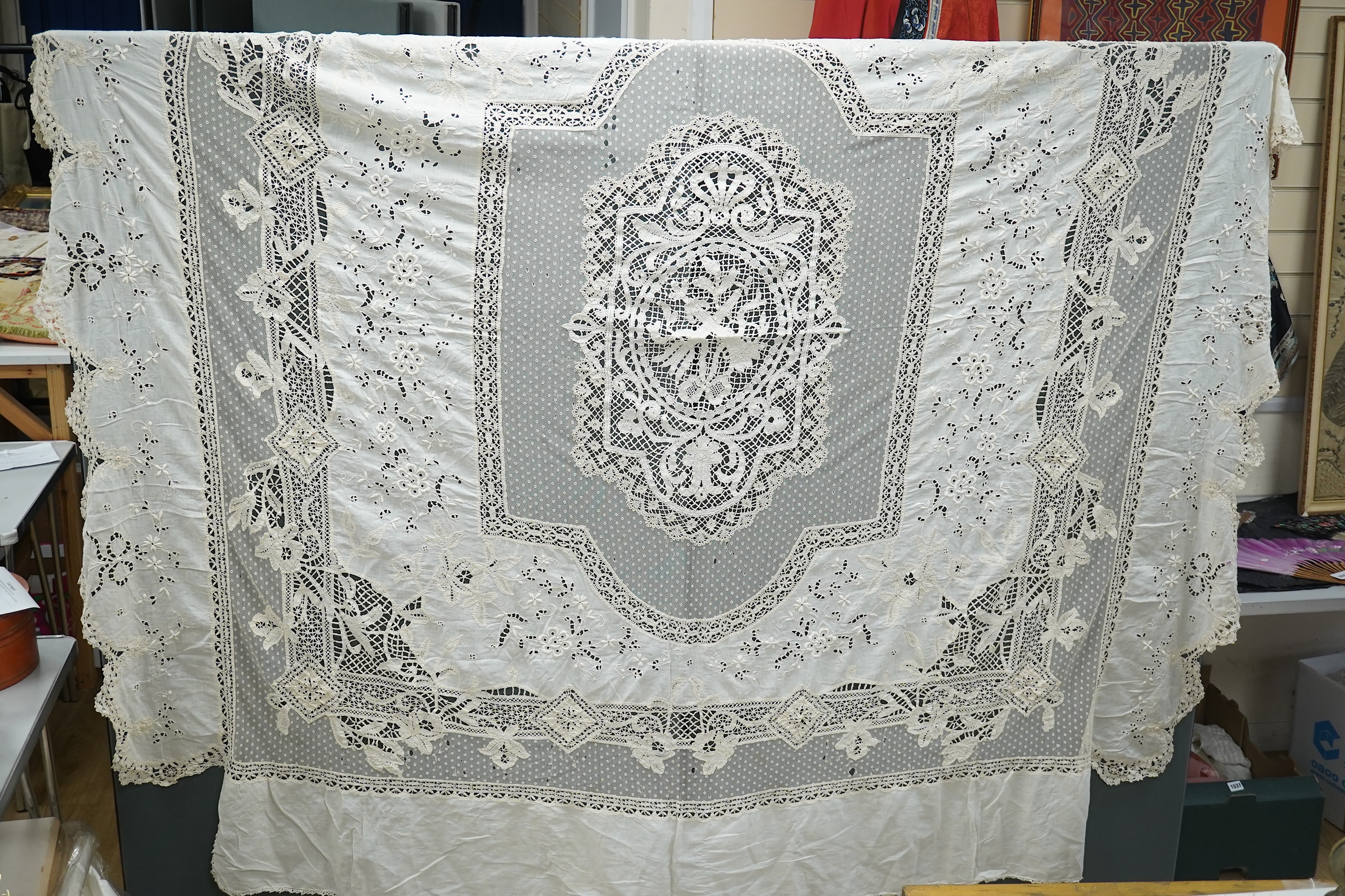 An ornate Edwardian bed cover, handmade from cut work anglaise panels, fine spot motif net and bobbin lace insertions, 228cm wide x 228 cm long. Condition - the spot motif net and fine lawn are damaged in places, the law